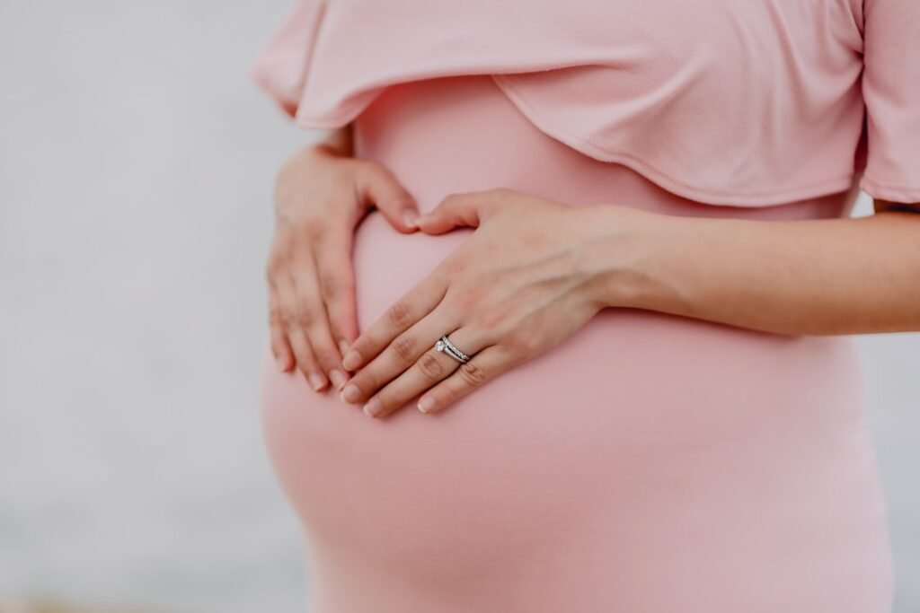 Expectant mother holding her baby bump, representing the importance of mineral-balanced hydration during pregnancy for fetal development.
