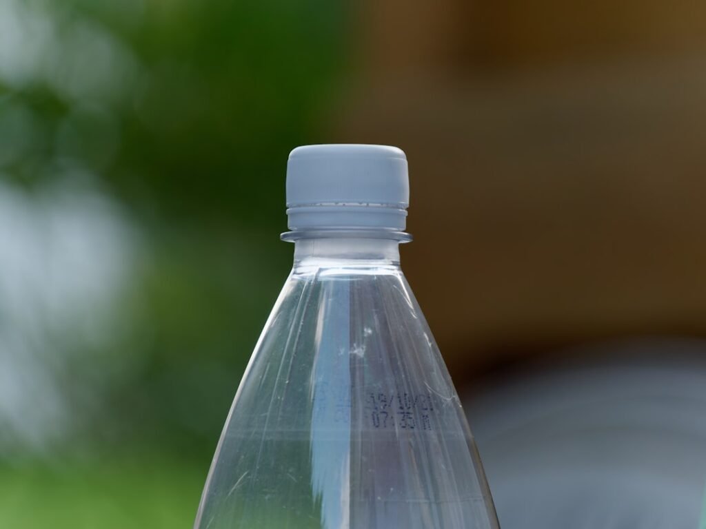 Close-up of a tamper-evident sealed water bottle cap showing intact factory seal